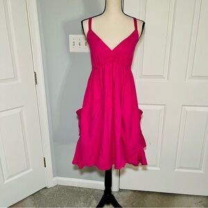 Hot pink dress with large side pockets.